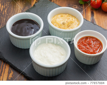 sauces: cheese garlic and tomato, in small saucers on a black stone stand 77857884