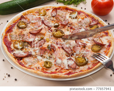 spicy pizza with sausage meat and jalapeno spicy pizza with sausage meat and jalapeno 77857941