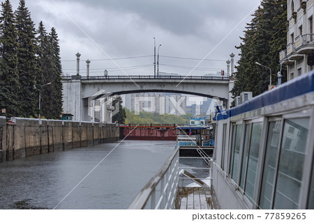 Old gateway on the Moskva River in cloudy rainy weather. Russia Old gateway on the Moskva River in cloudy rainy weather. Russia 77859265
