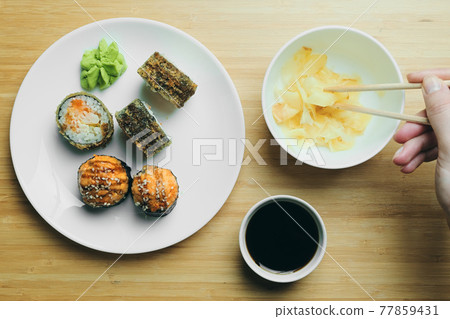 Japanese kitchen. Set of Japanese sushi and rolls. Food sticks. Japanese kitchen. Set of Japanese sushi and rolls. Food sticks. 77859431