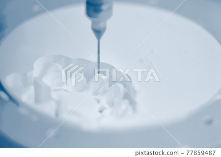 Dental milling machine carving out shape of human teeth 77859487