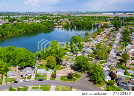 Aerial panorama view of the residential Sayreville town area of beautiful suburb of dwelling home near lake from a height in New Jersey US 77860429