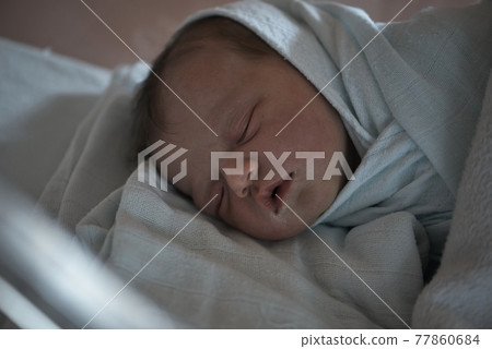 newborn baby sleeping in bed at hospital 77860684