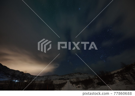 Aurora borealis Green northern lights above mountains Aurora borealis Green northern lights above mountains 77860688