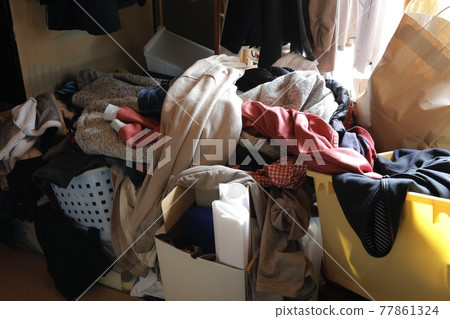 A pile of clothes in the room A pile of clothes in the room 77861324