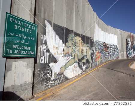 Activist graffiti adorns the Israeli separation wall in the West Bank town of Bethlehem 77862585