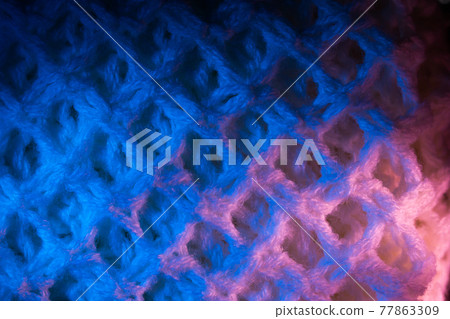 Close-up of fluffy soft textile. Abstract fabric with knit texture for background. 77863309