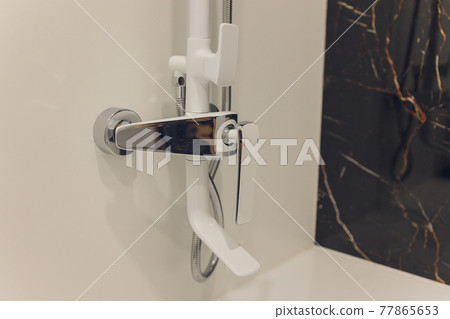 Water flowing in a old metal shower - swallow DOF.focus on top.some water drops are blurry due to water speed. Water flowing in a old metal shower - swallow DOF.focus on top.some water drops are blurry due to water speed. 77865653