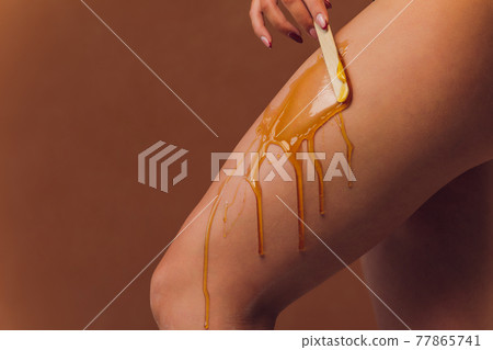 Hair removal with sugar. In the office of a cosmetologist. Hair removal with sugar. In the office of a cosmetologist. 77865741