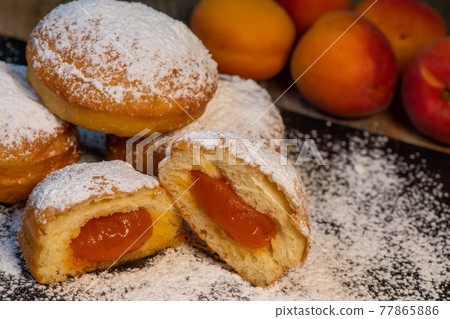 Freshly cooked Apricot jam doughnuts, referred to as jelly doughnuts, donuts in the US Freshly cooked Apricot jam doughnuts, referred to as jelly doughnuts, donuts in the US 77865886
