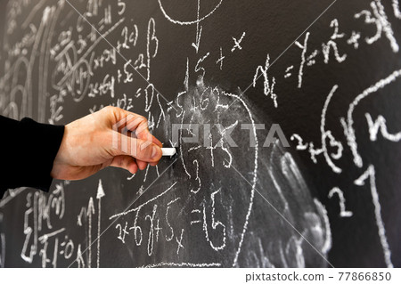 Mathematical formulas on dark black chalk board 77866850
