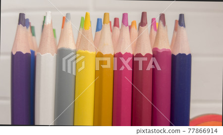 A set of colored pencils, stationery. A lot of multicolored pencils on the table. 77866914