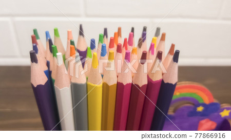 A set of colored pencils, stationery. A lot of multicolored pencils on the table. 77866916