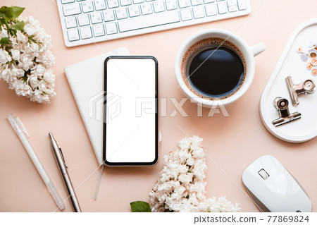 Neutral color tabletop with keyboard, lilac flowers and smartpohone mock-up with white screen isolated Neutral color tabletop with keyboard, lilac flowers and smartpohone mock-up with white screen isolated 77869824