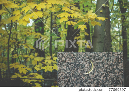 White crescent moon symbol on the grave rectangular granite slab. Muslim background 77869897