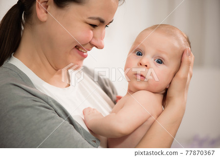 Close up portrait of mother and her newborn baby. Healthcare and medical love woman lifestyle mother Close up portrait of mother and her newborn baby. Healthcare and medical love woman lifestyle mother 77870367
