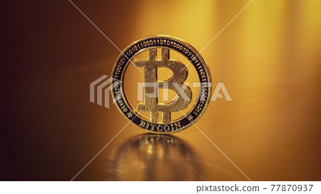Bitcoin wallet. Golden Bit Coin virtual cryptocurrency or blockchain technology. Gold Crypto currency BTC Bitcoin on black background. Investing in virtual assets, Bull market trend concept. 77870937