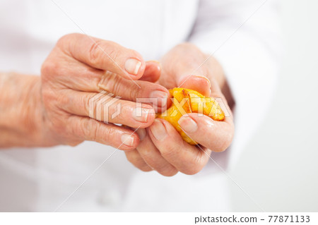 Senior woman preparing a traditional dish from el Valle del Cauca in Colombia called aborrajado Senior woman preparing a traditional dish from el Valle del Cauca in Colombia called aborrajado 77871133