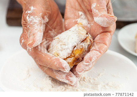 Senior woman preparing a traditional dish from el Valle del Cauca in Colombia called aborrajado Senior woman preparing a traditional dish from el Valle del Cauca in Colombia called aborrajado 77871142