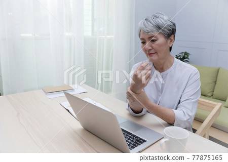 Elderly professional woman working from home during covid-19 pandemic Elderly professional woman working from home during covid-19 pandemic 77875165