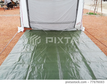 Setting up a tent at the campsite Setting up a tent at the campsite 77876083