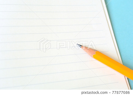 New horizontal ruled notebook and pencil blue background 77877086