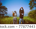 Couples travel nature. Travel relax. Standing natural touch grass on the Mountain 77877443