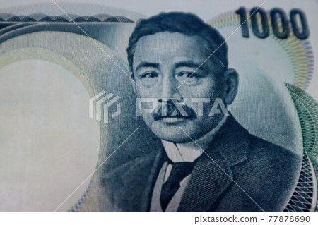 Close-up of the surface of a thousand yen on an old Japanese bill Close-up of the surface of a thousand yen on an old Japanese bill 77878690