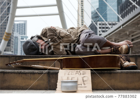 beggar or Homeless man sleep and get cold at winter 77883302