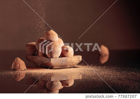 Chocolate truffles in small wooden dish. Chocolate truffles in small wooden dish. 77887207