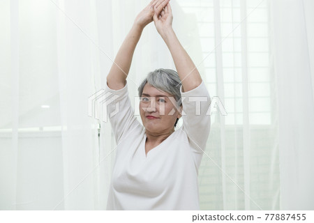 Seniors doing yoga and aerobics at home Seniors doing yoga and aerobics at home 77887455