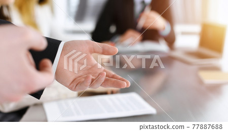 Business presentation. Businessman giving speech to colleagues and partners at corporate meeting or conference, close-up of speaker hands 77887688