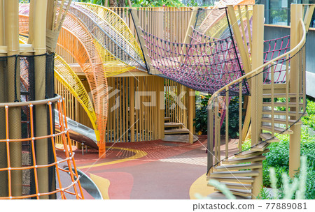 Shaded kid's playground activity tower equipment at park. Children's playing area indoor with toys equipment. Shaded kid's playground activity tower equipment at park. Children's playing area indoor with toys equipment. 77889081