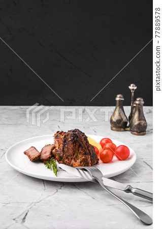Lamb saddle marinated in mustard baked in oven Lamb saddle marinated in mustard baked in oven 77889578