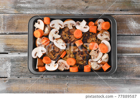 Lamb neck with champignon and vegetables baked in oven Lamb neck with champignon and vegetables baked in oven 77889587