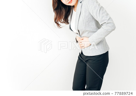 Young woman suffering from abdominal pain and menstrual cramps Young woman suffering from abdominal pain and menstrual cramps 77889724