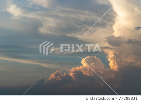 Beautiful sunset sky above clouds with dramatic light. Beautiful blazing sunset landscape, Horizon. Warm Colours. 77889831