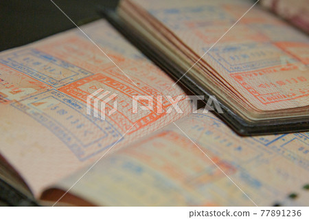 open passport pages with marks and stamps on crossing the border open passport pages with marks and stamps on crossing the border 77891236