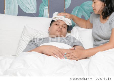 Asian mother wiped son's body to reduce fever in bedroom, 77891713