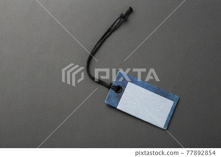 Blank tag tied with string. 77892854