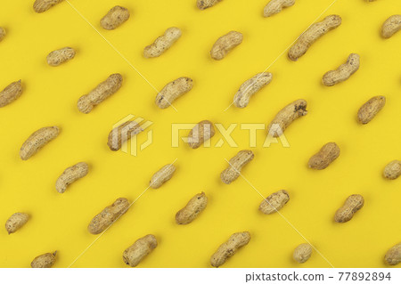 Peanuts pattern isolated on a yellow backround. Repetition concept. Peanuts pattern isolated on a yellow backround. Repetition concept. 77892894