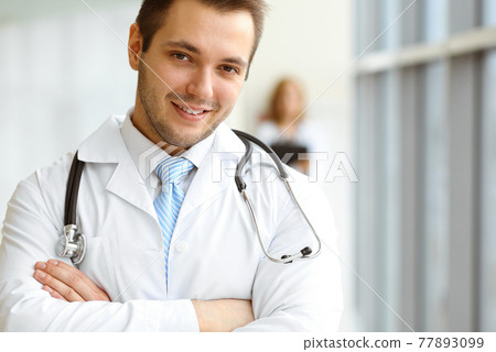 Male dark hair doctor standing in the modern clinic. Perfect medical service in the hospital. Medicine concept 77893099