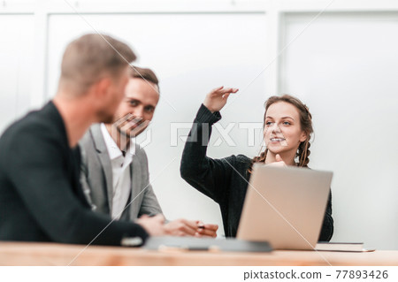 young business woman makes a report at a group meeting young business woman makes a report at a group meeting 77893426