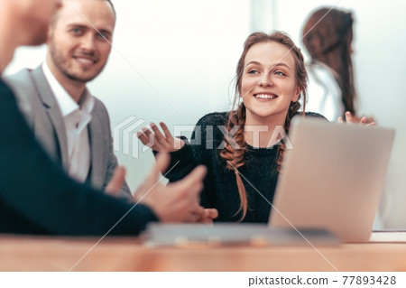 side view. business colleagues use laptop at office meeting side view. business colleagues use laptop at office meeting 77893428