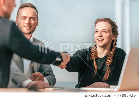 young coworkers shaking hands with each other in the group meet young coworkers shaking hands with each other in the group meet 77893429