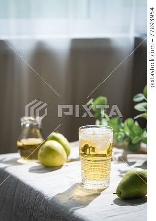 Glass of pear fresh juice or cider Glass of pear fresh juice or cider 77893954