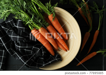 Concept of fresh vegetable with carrot on dark wooden table Concept of fresh vegetable with carrot on dark wooden table 77895885