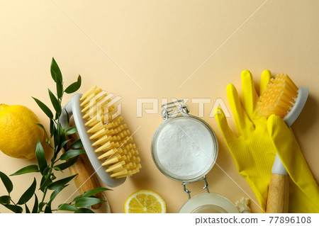 Cleaning concept with eco friendly cleaning tools and lemons on beige background 77896108