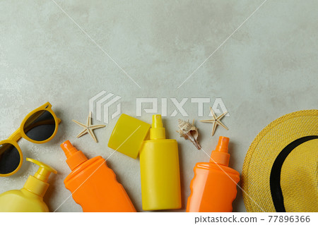 Summer concept with sunscreens on textured background Summer concept with sunscreens on textured background 77896366