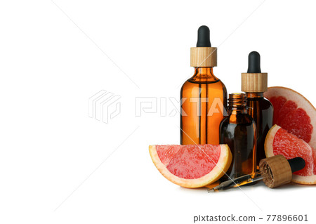Dropper bottles with oil and grapefruit isolated on white background 77896601